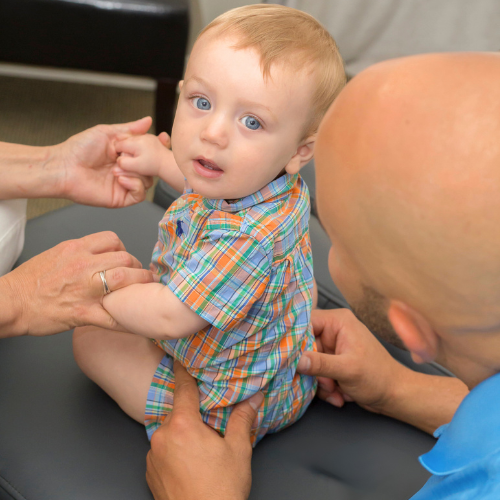 Chiropractor in Knoxville TN Dr. Vic Manzo palpating an infant at The Wellness Path