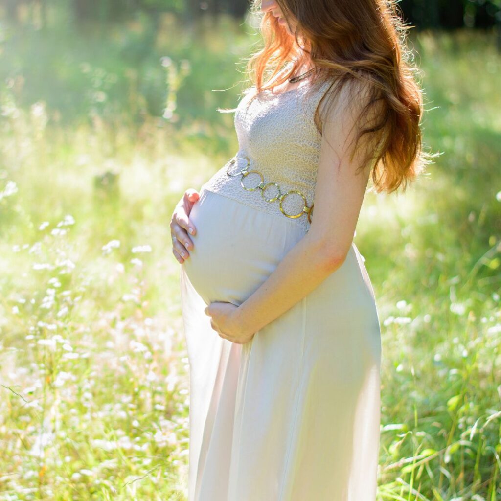 Pregnant woman cradling her baby bump — webster certified and prenatal chiropractor in Knoxville TN, Morristown TN, and Maryville, TN