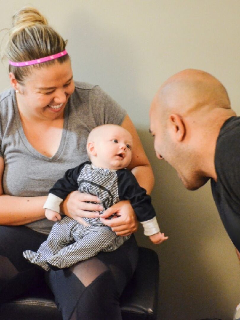 Chiropractor in Morristown TN Dr. Vic Manzo consulting with a mother and infant at The Wellness Path