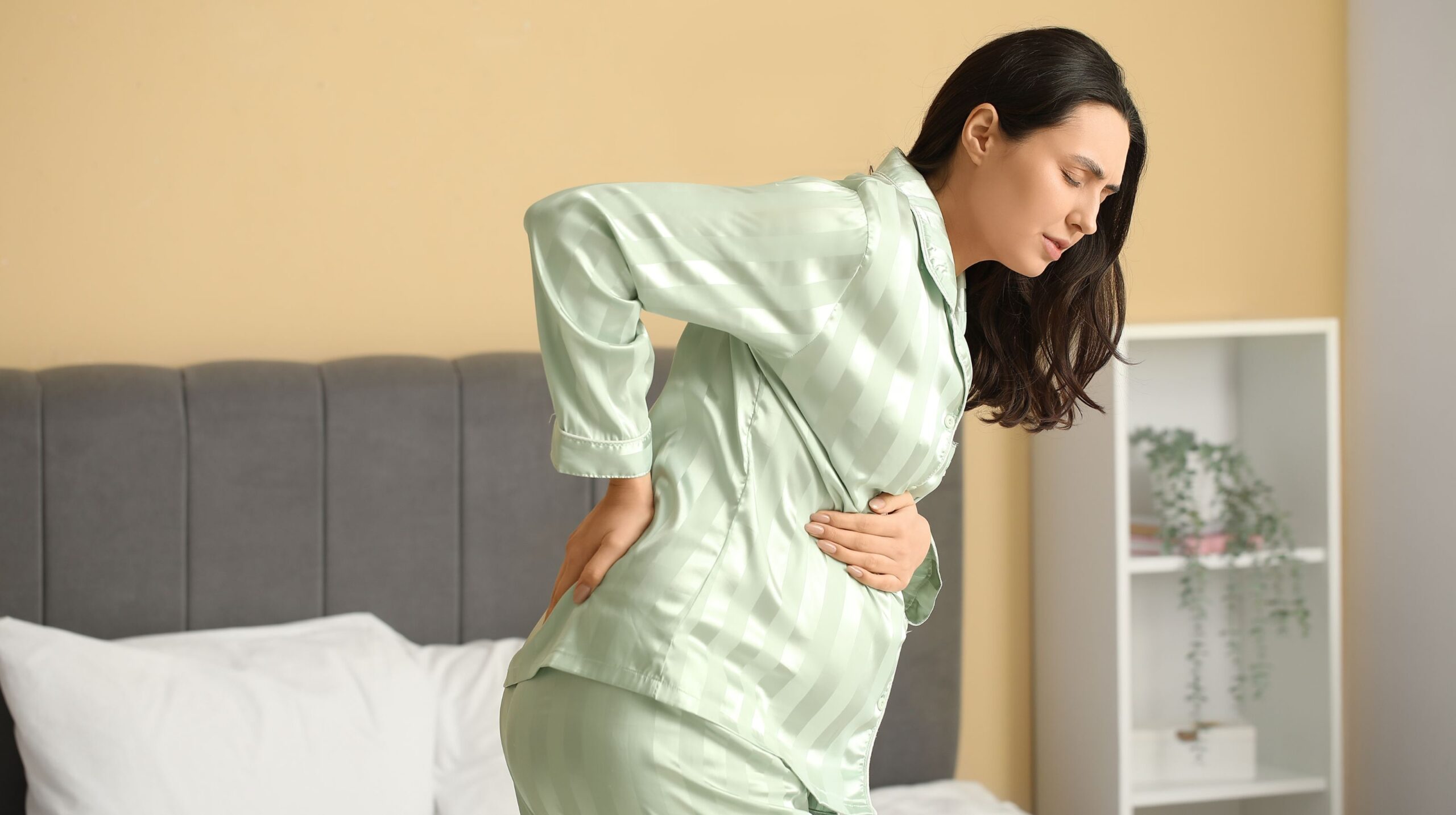 Pregnant woman receiving Webster Technique chiropractic care for hip pain at The Wellness Path in Knoxville TN